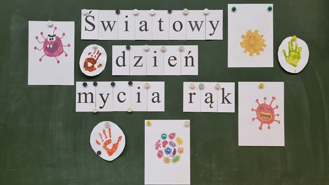 Tablica z napisem Światowy dzień mycia rąk i ilustracjami zarazków.